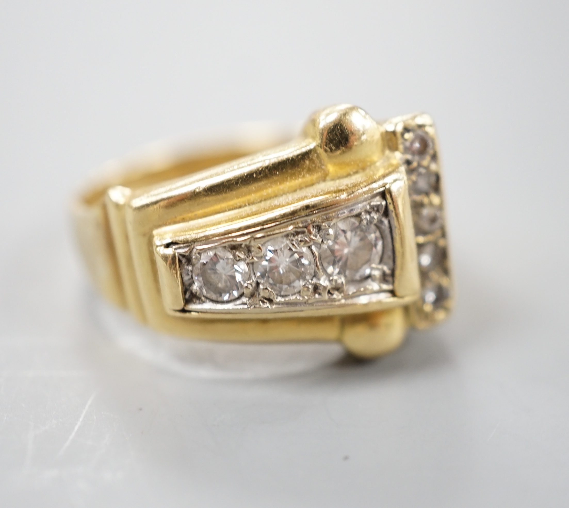 A 1950's yellow metal and graduated eight stone diamond set dress ring, size P/Q, gross 10 grams.